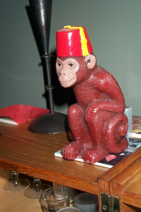 Monkey-With-Fez Candle Overlooks The Proceedings